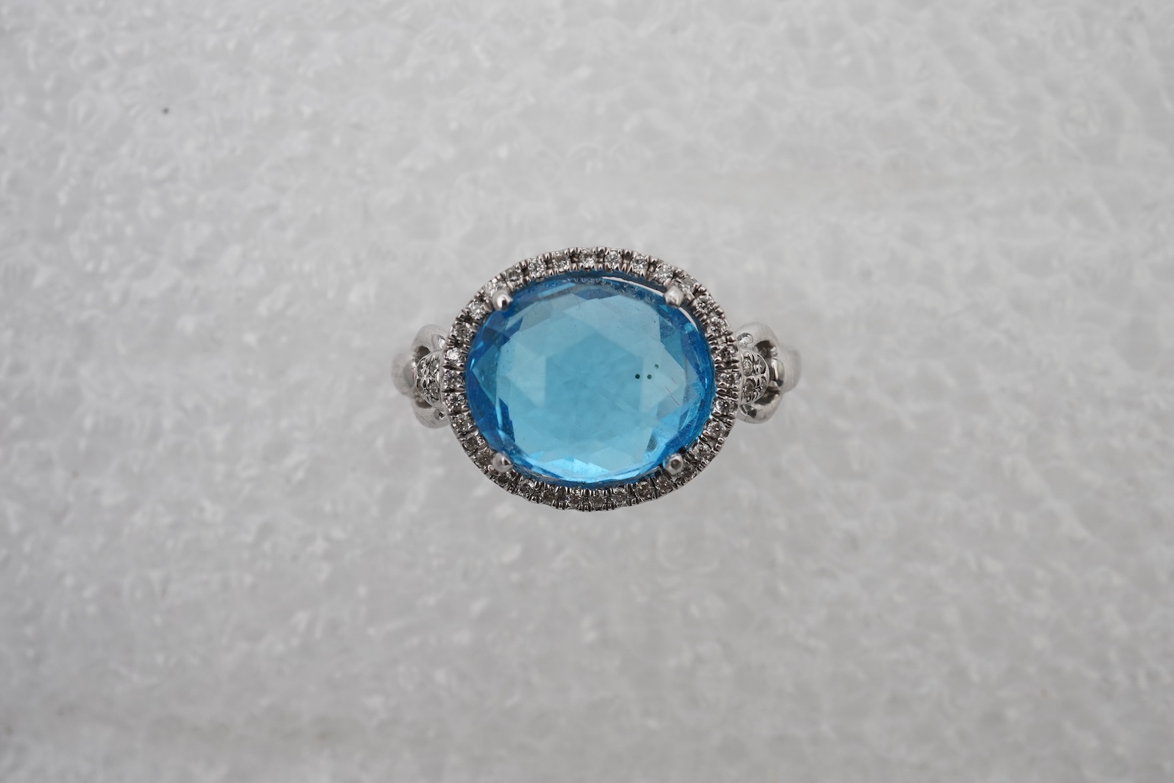 A blue topaz and diamond ring